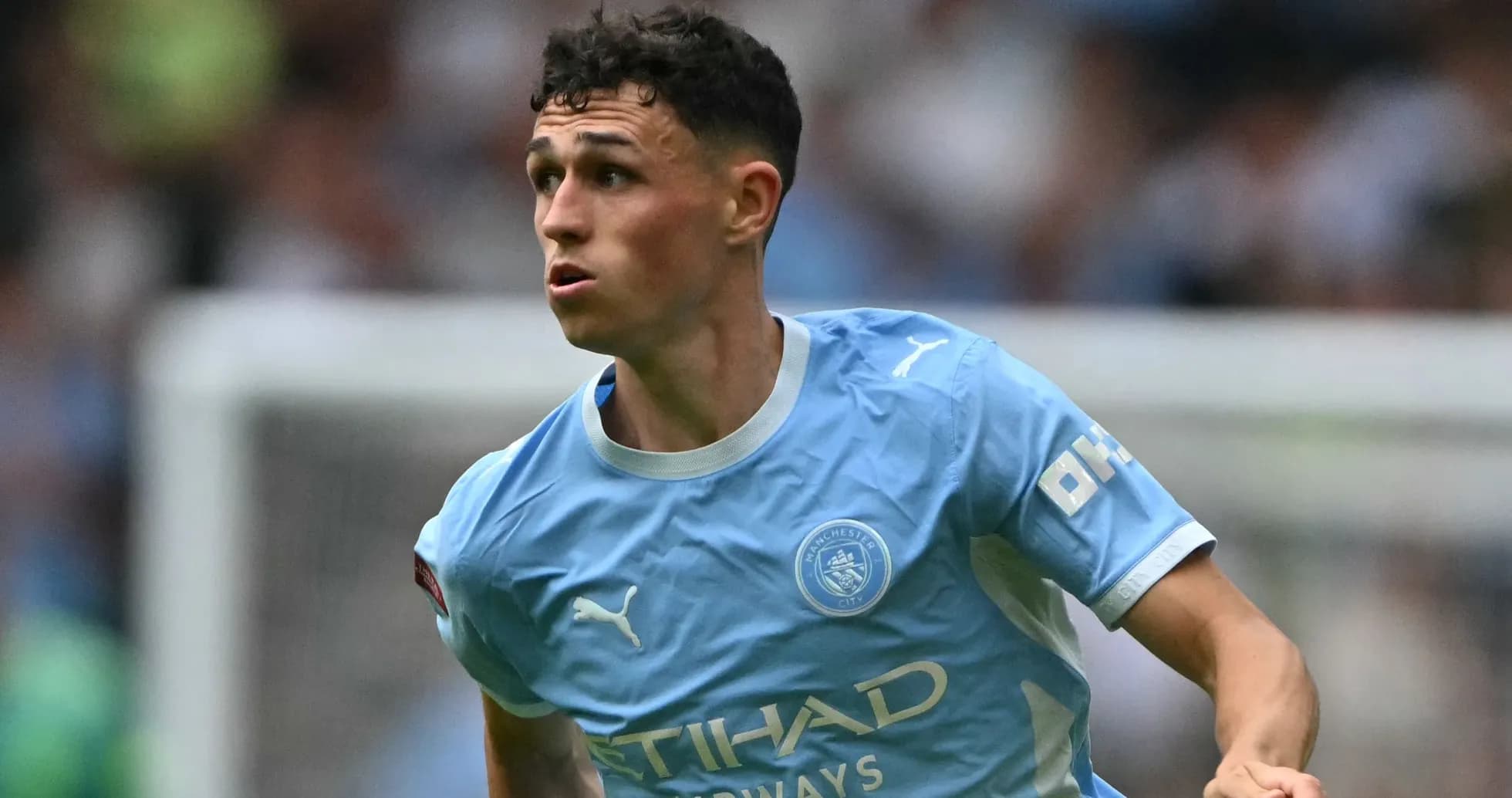Phil Foden running on the pitch during match