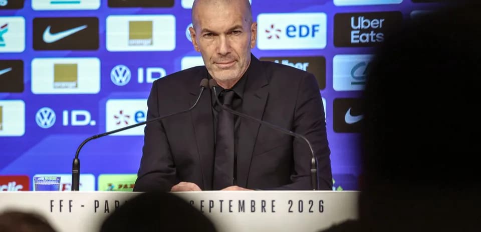 Manager at press conference with sponsor backdrop