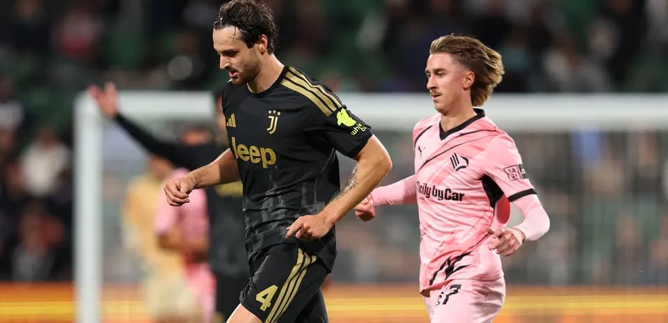 Juventus player running with opponent in pursuit