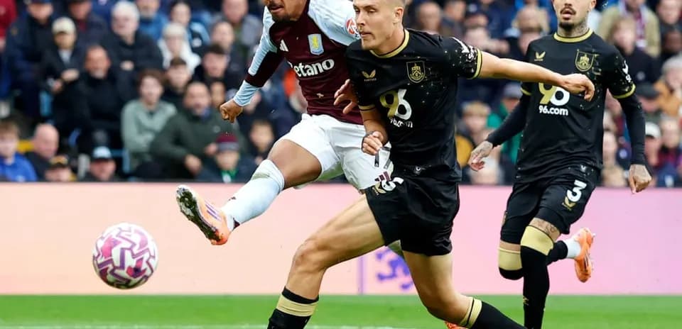 Aston Villa player shooting during match against Burnley
