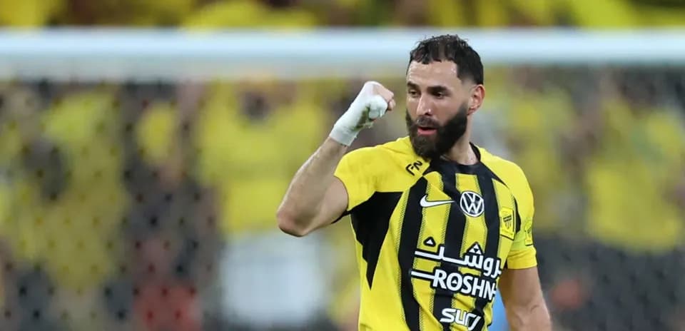 Player celebrating a goal in yellow and black jersey