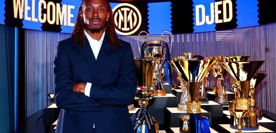 Player posing in front of trophies at event