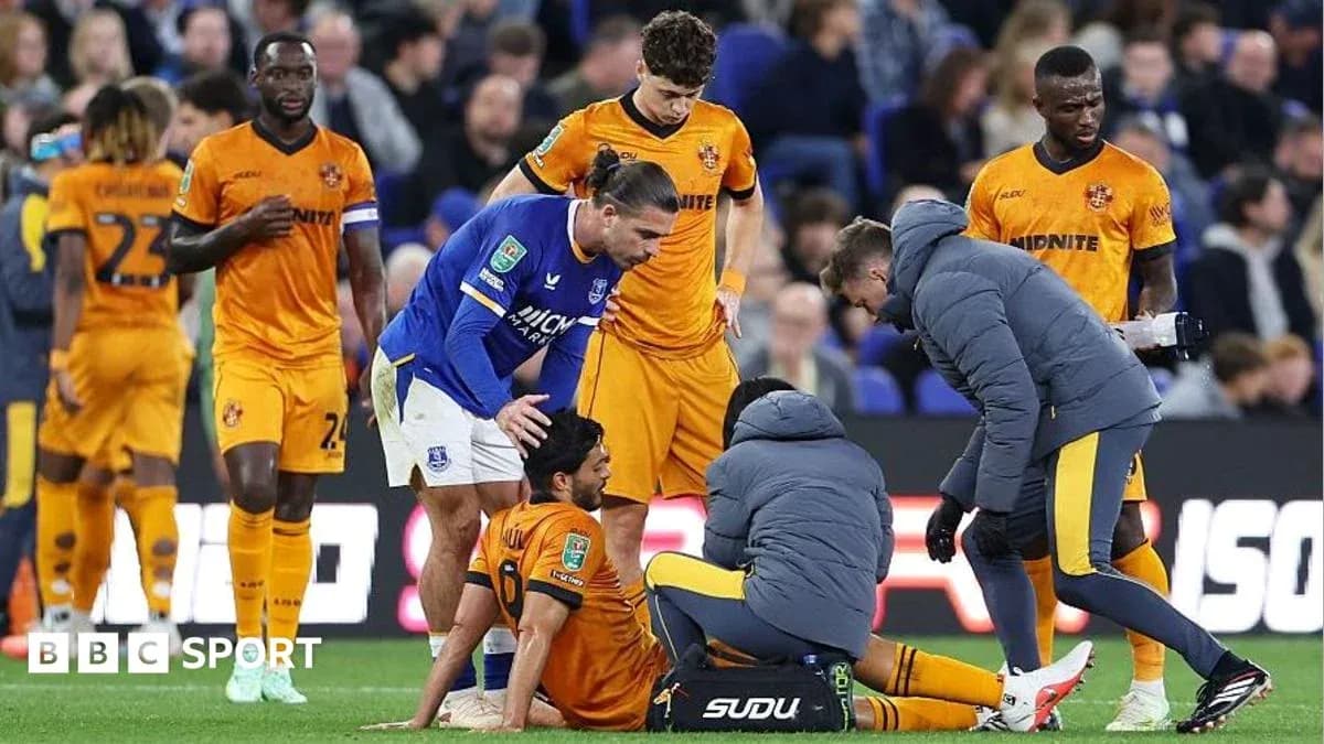 Players and medical staff attending to injured player