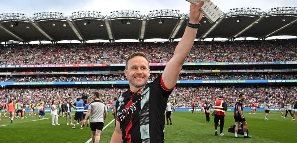 Player celebrating with a score sheet on field