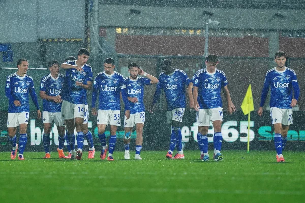 Como players walking off the pitch in rain