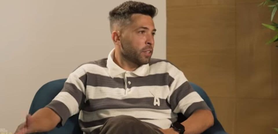 Person speaking while seated in an armchair