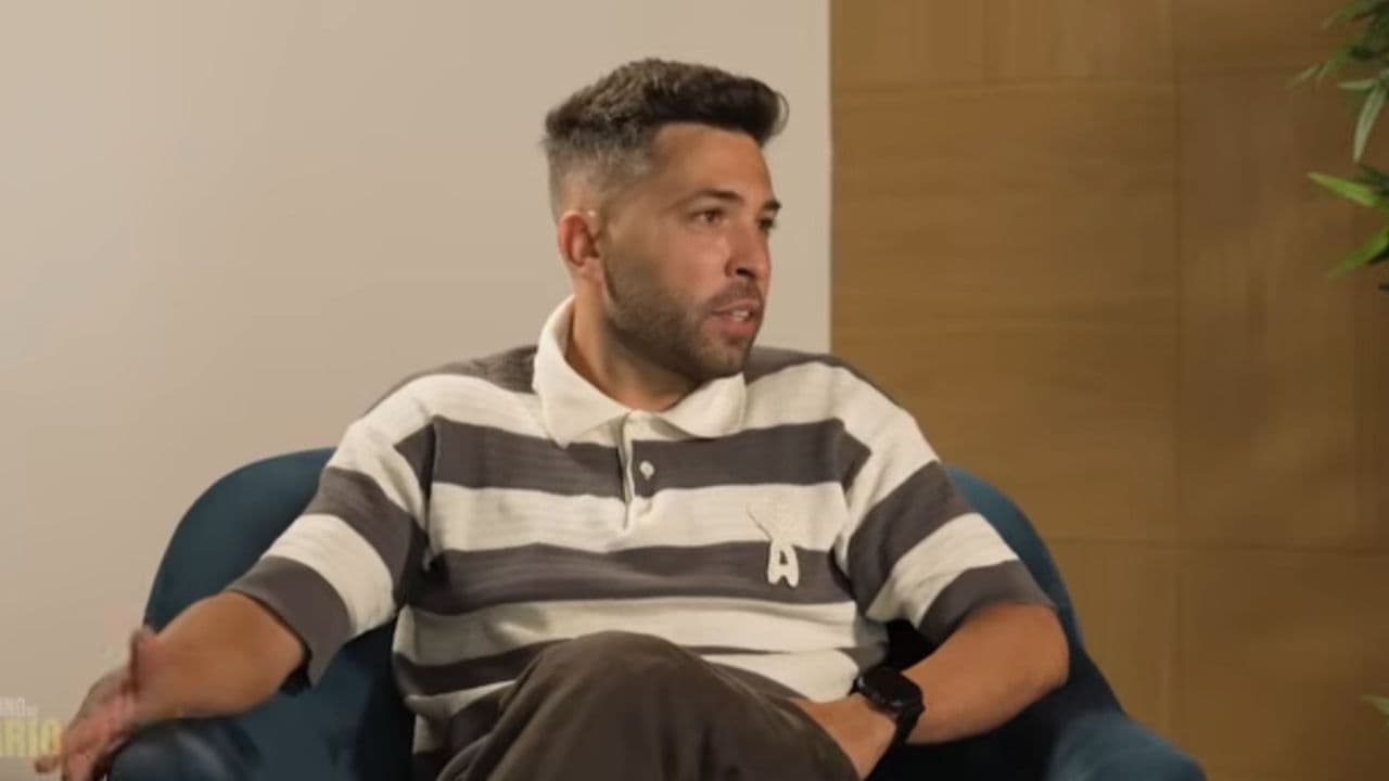 Person speaking while seated in an armchair