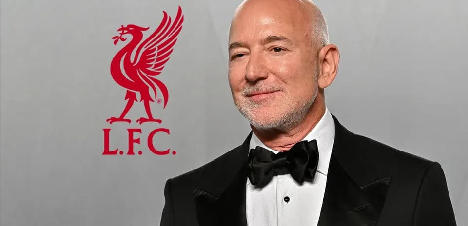 Man in tuxedo with Liverpool FC logo background