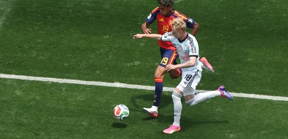 Two players competing for the ball on field