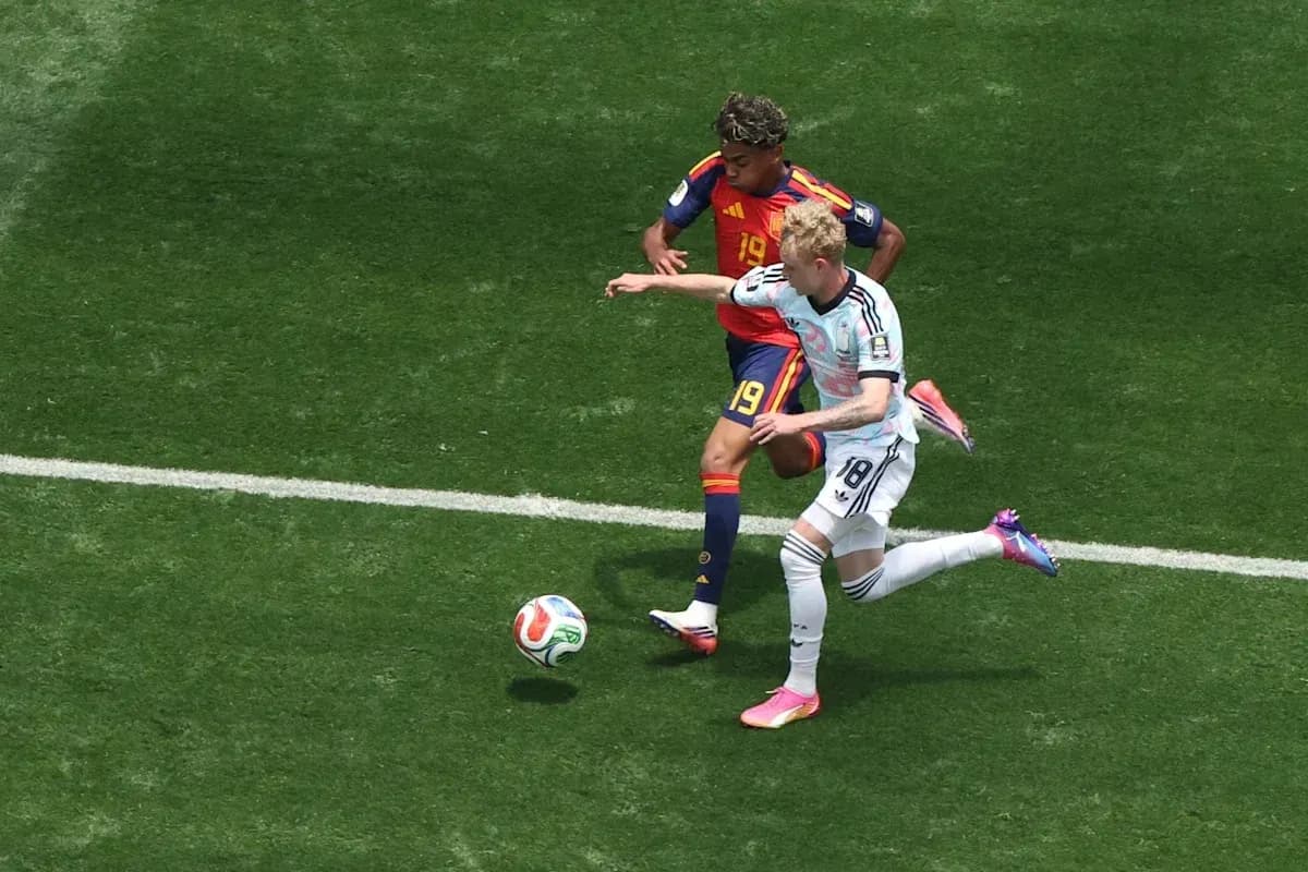 Two players competing for the ball on field
