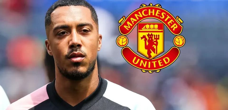 Player in jersey with Manchester United logo behind