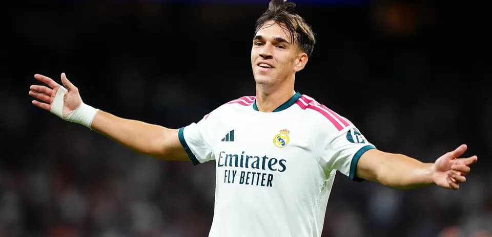 Player celebrating in Real Madrid jersey on pitch