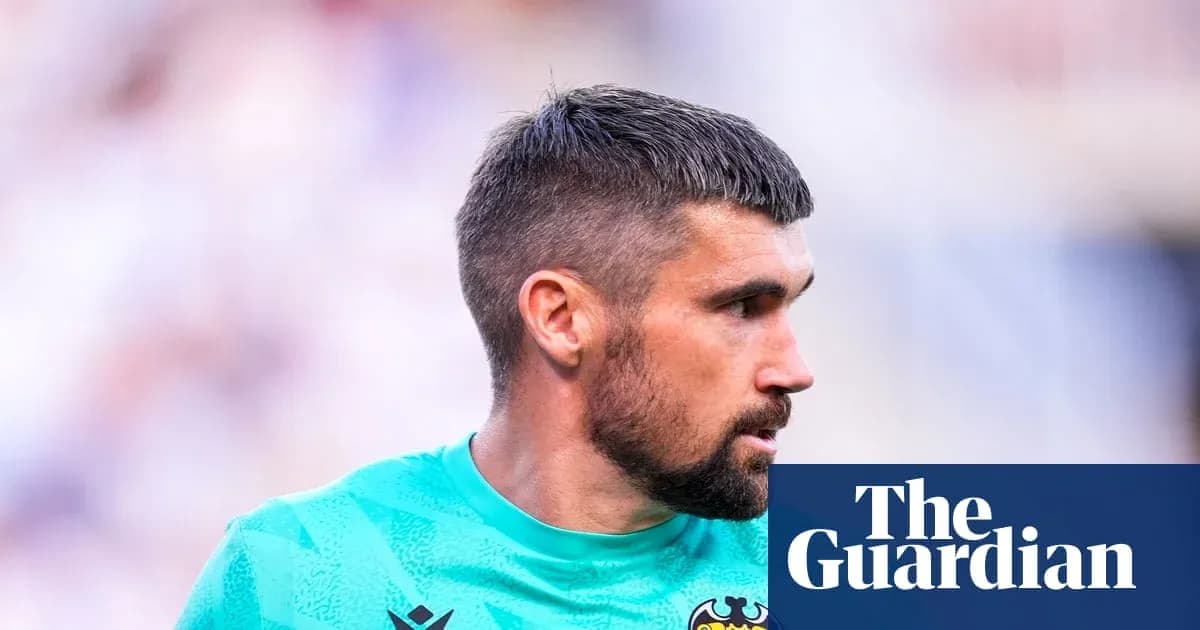 Goalkeeper in green kit during match warm-up