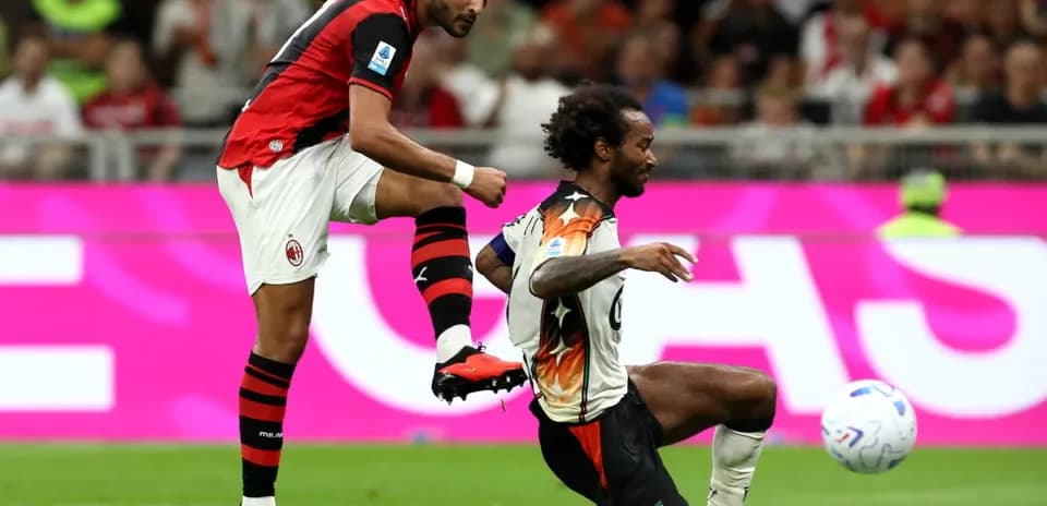 AC Milan player kicking ball during match