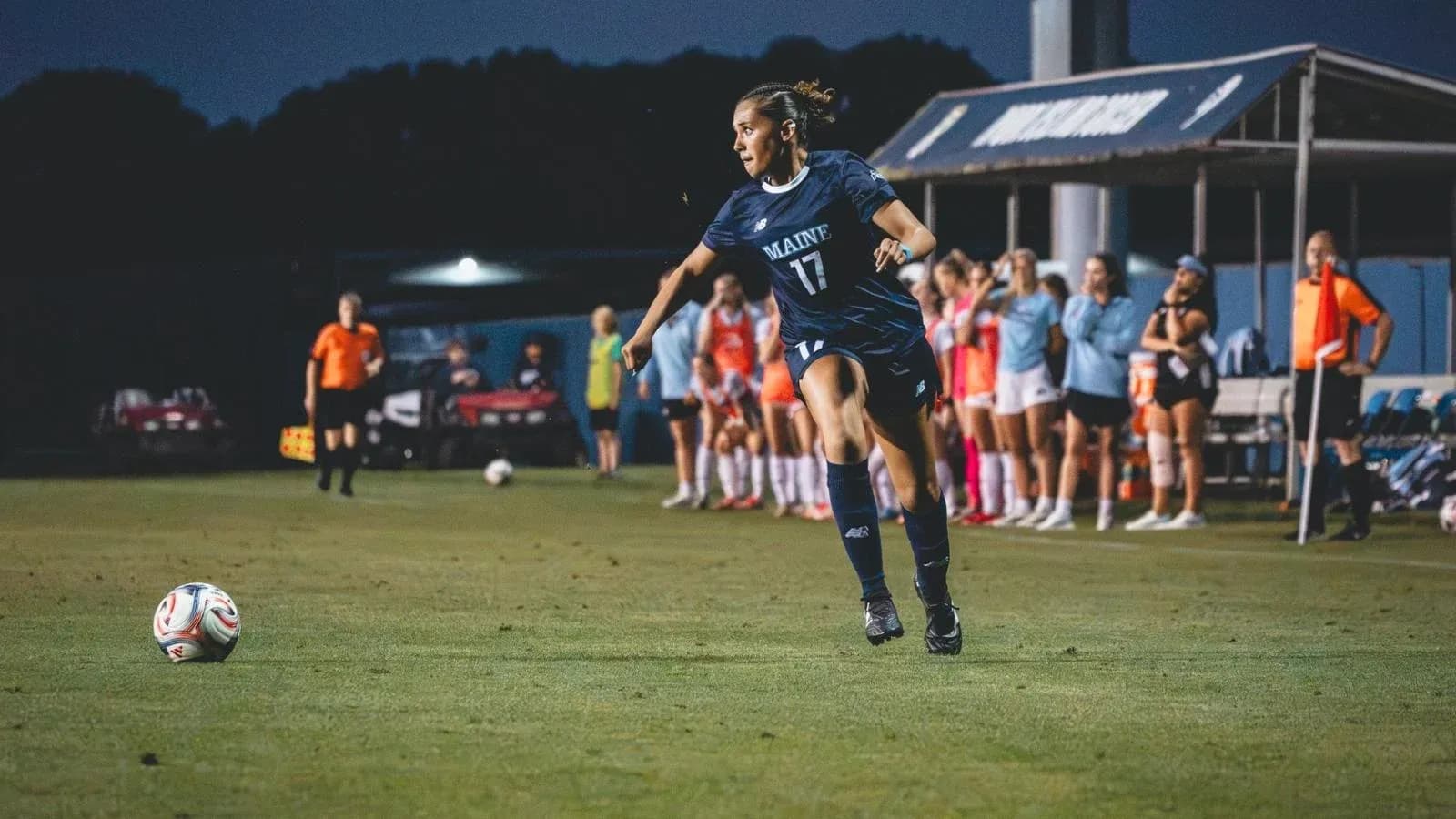 Player from Maine kicking ball during soccer match