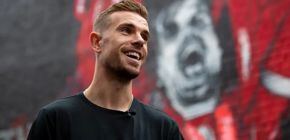 Player smiling in front of mural backdrop