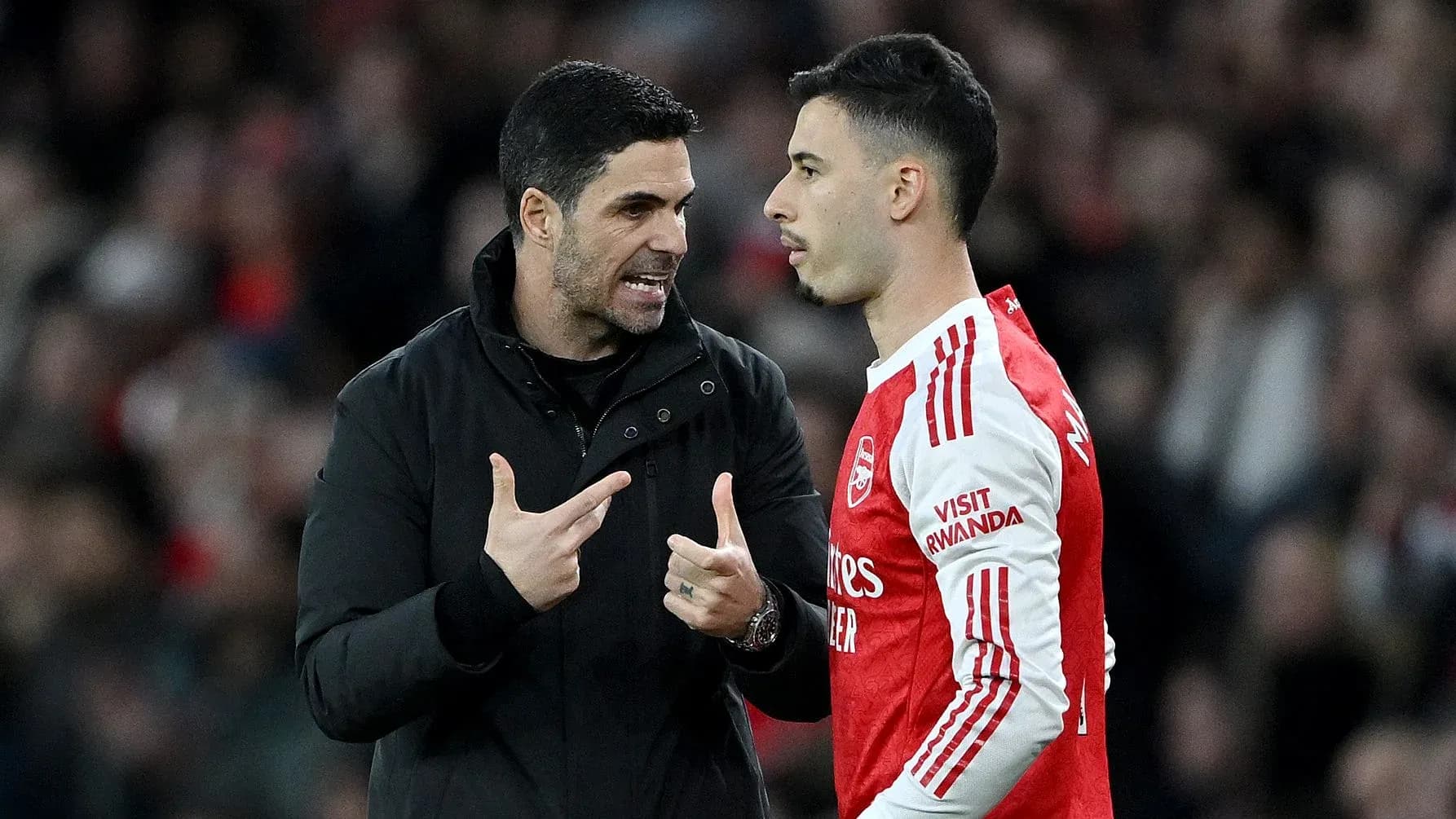 Manager discussing strategy with player on sideline