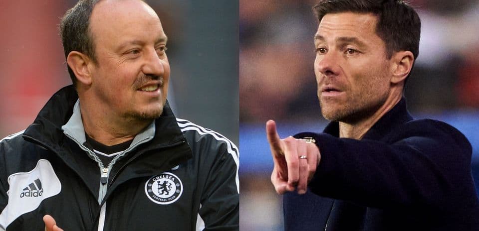 Two football managers discussing strategy on the sidelines