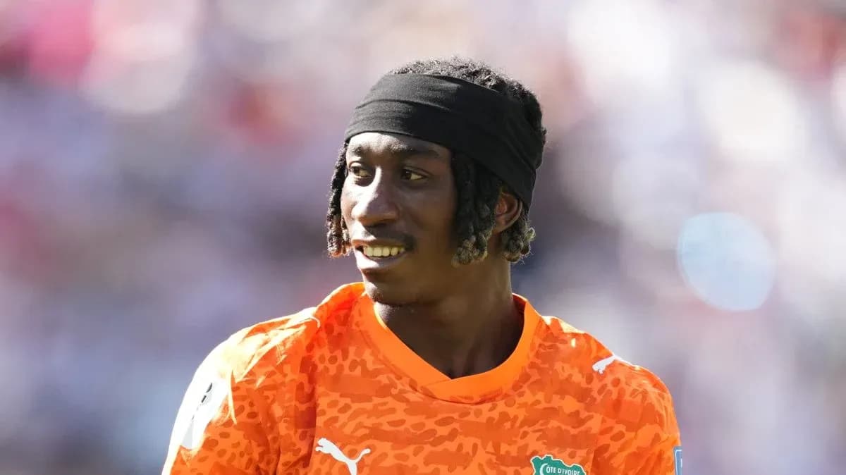 Goalkeeper in orange kit during warm-up session