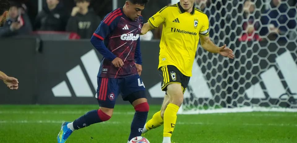 Players competing for the ball in MLS match