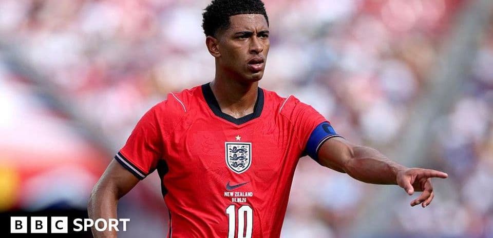 Player in red England kit signaling during match