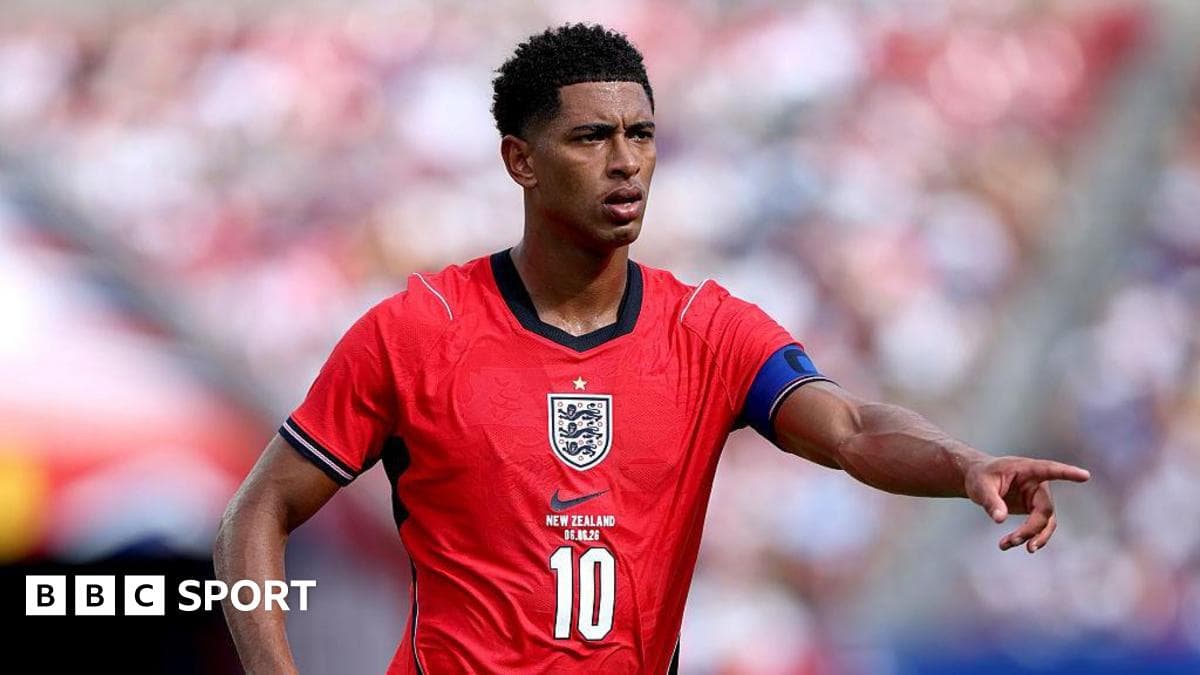 Player in red England kit signaling during match