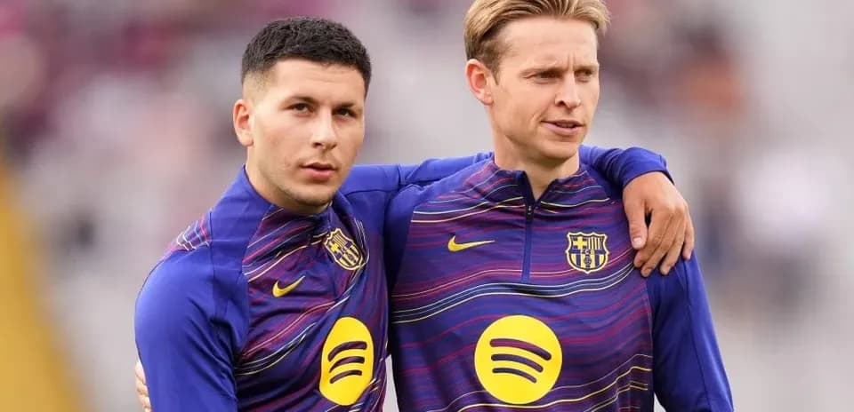 Two players in Barcelona training kits on the field