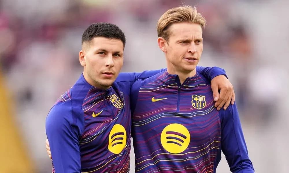 Two players in Barcelona training kits on the field