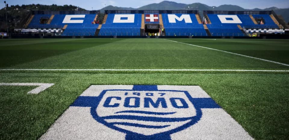 Como stadium with team logo on the field