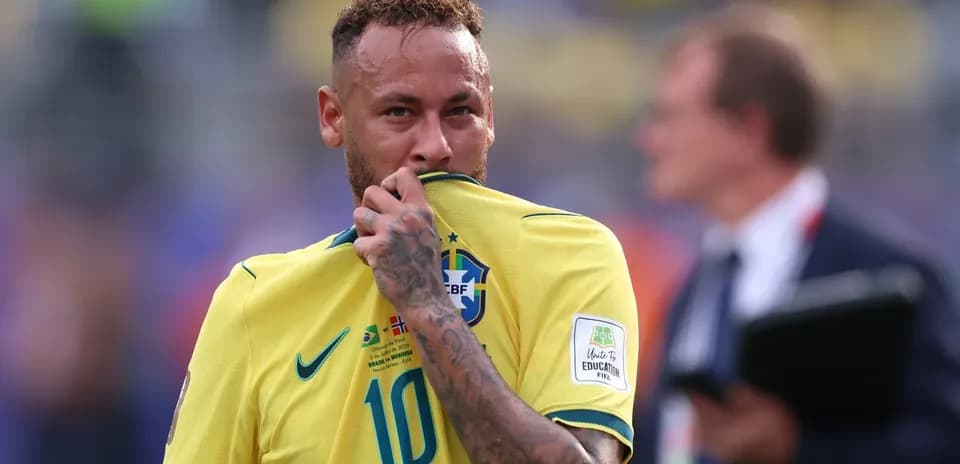 Neymar holding his jersey during match