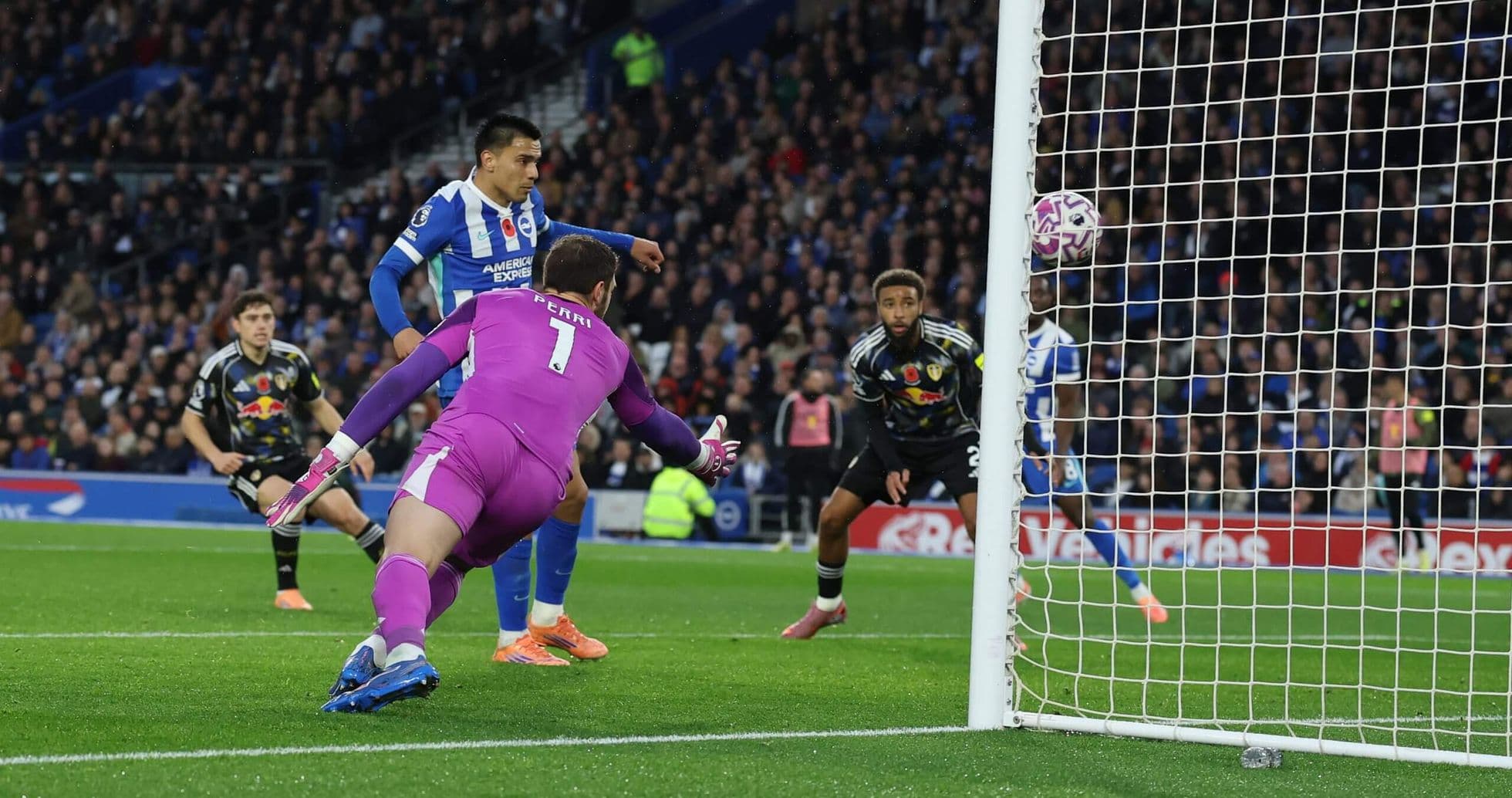 Goalkeeper attempting to save a shot on goal