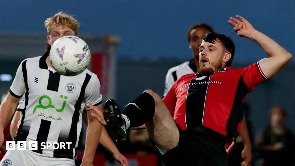 Player kicking ball during football match action