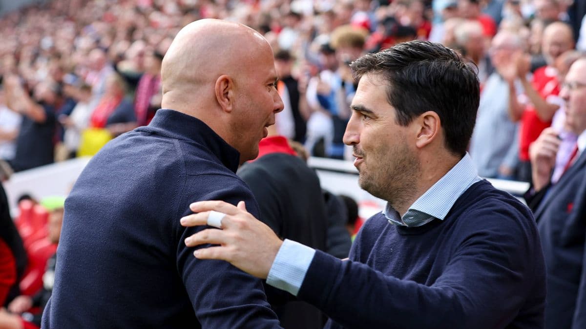 Two coaches greeting each other before the match