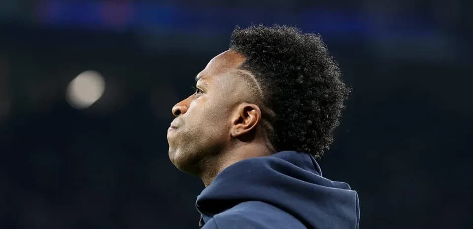 Player in hoodie looking away from the camera