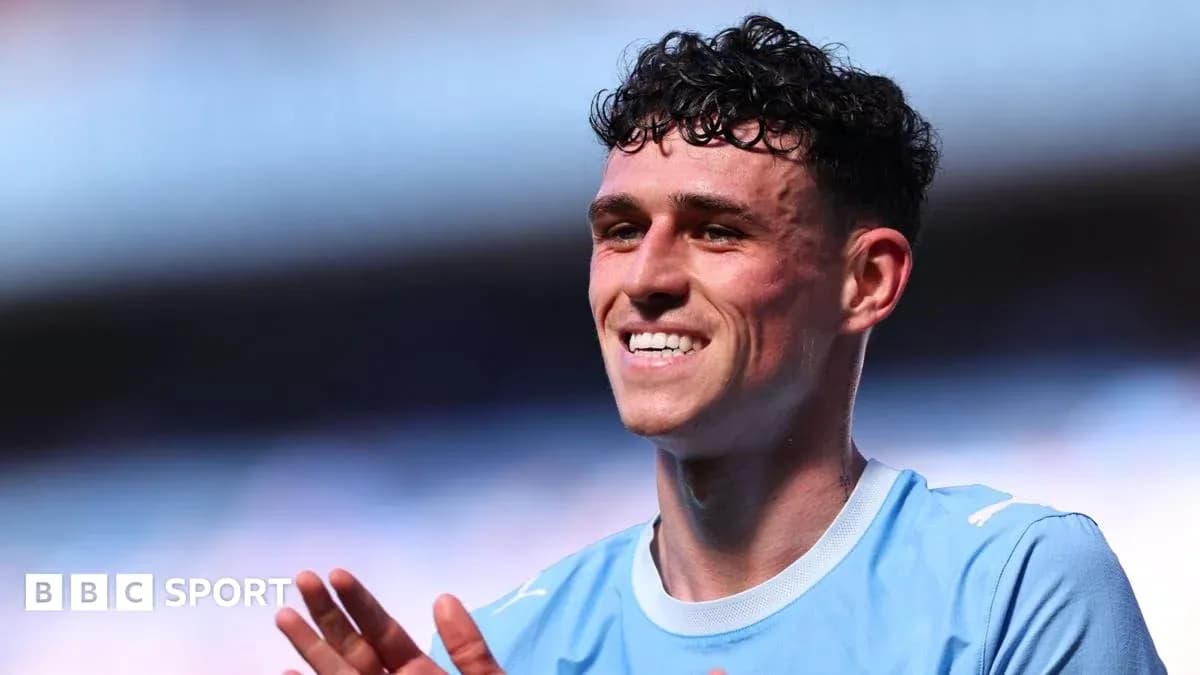Player smiling and applauding in light blue jersey