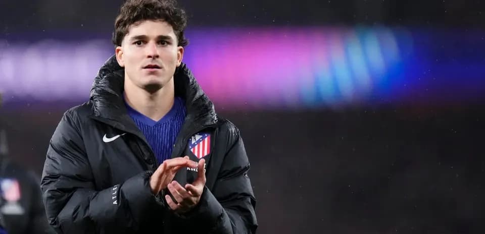Player applauding while wearing Atletico Madrid jacket