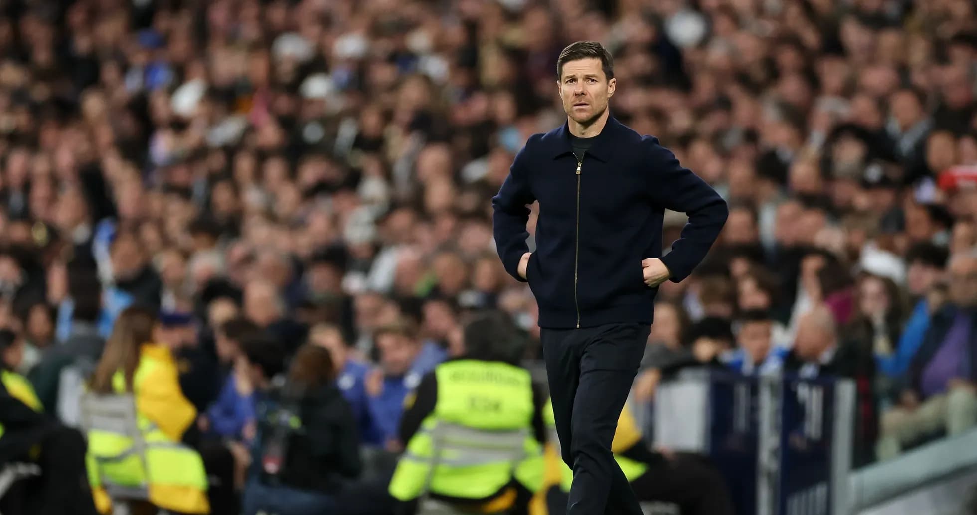 Coach walking along the sideline during match