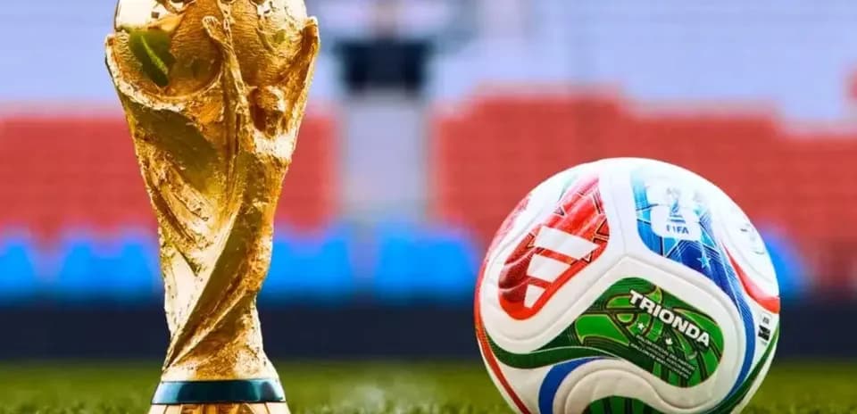 FIFA World Cup trophy next to soccer ball