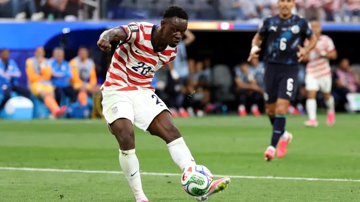 Player in striped jersey kicking soccer ball on field