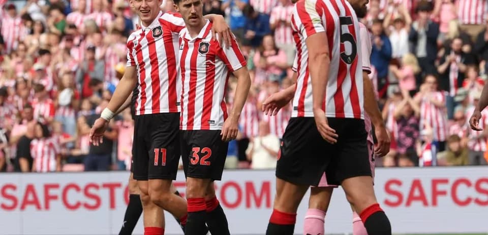 Sunderland players celebrating a goal together on field
