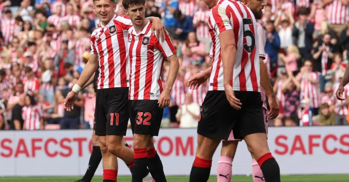 Sunderland players celebrating a goal together on field