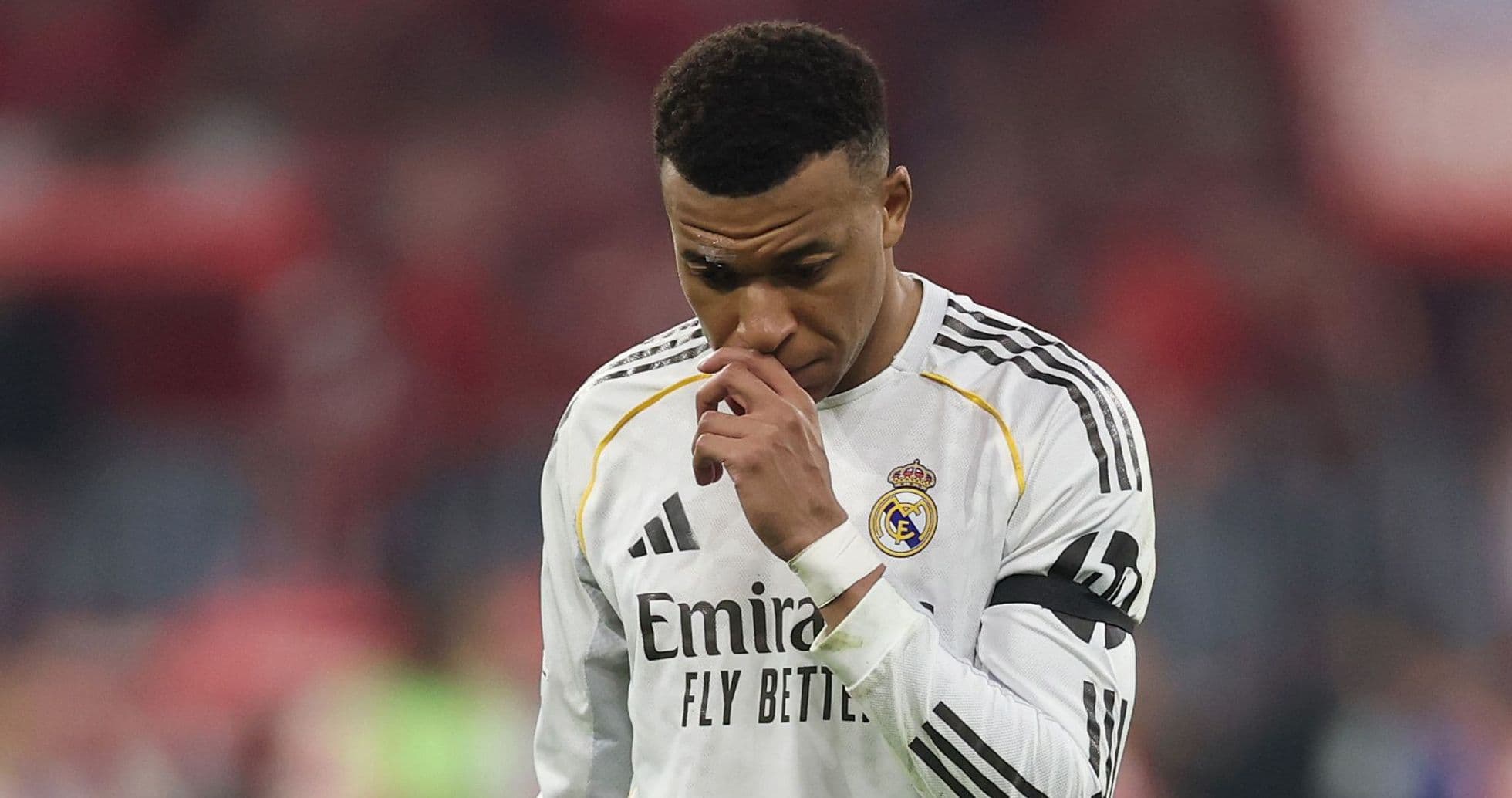 Player in Real Madrid jersey looking down