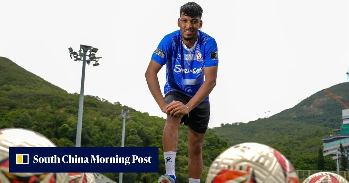 Football player posing with balls on training field
