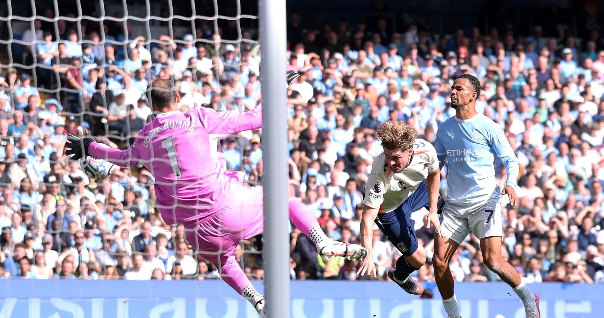 Player attempting to score as goalkeeper dives