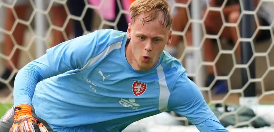 Goalkeeper diving to save the ball during practice