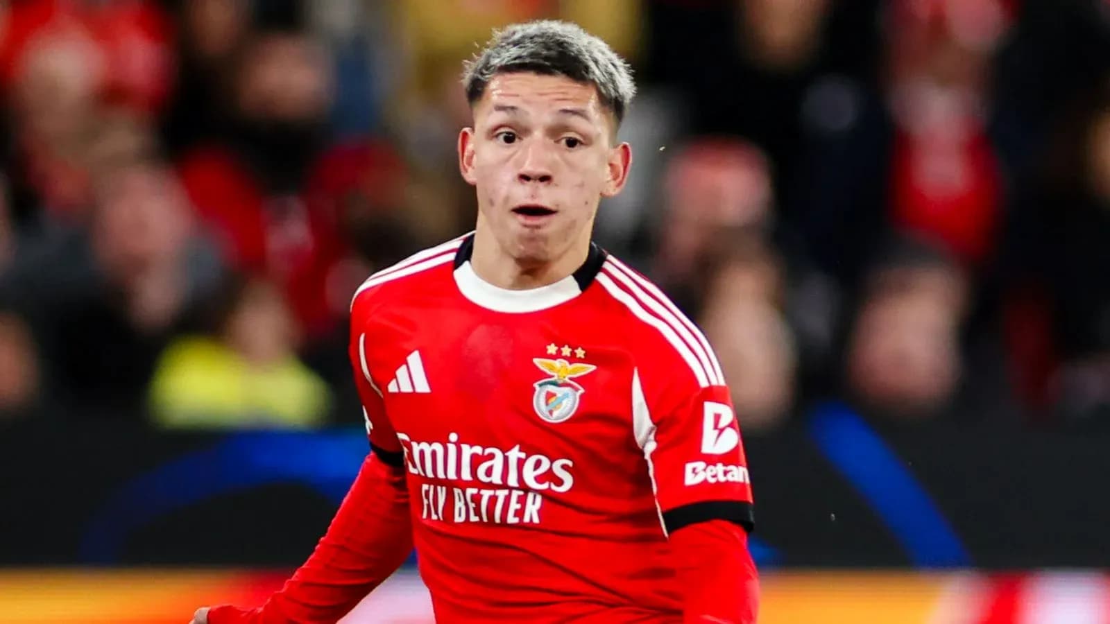 Player in red Benfica kit during match action