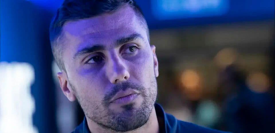 Athlete in a blue-lit environment looking thoughtful