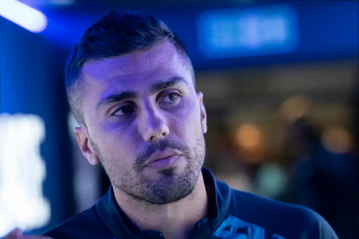 Athlete in a blue-lit environment looking thoughtful