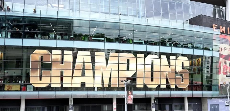 Exterior of Emirates Stadium displaying 'CHAMPIONS' sign
