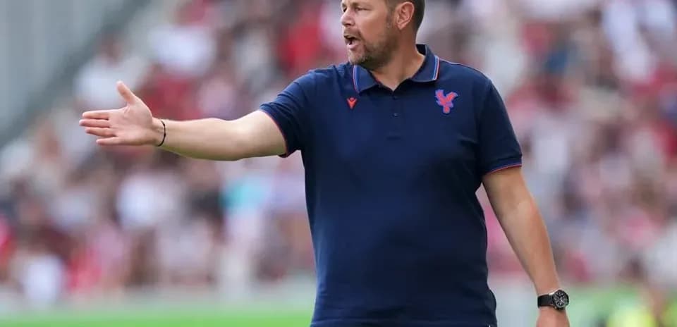 Manager gesturing from the sidelines during match